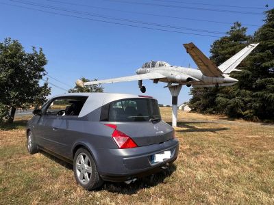 a small car parked in front of a small plane