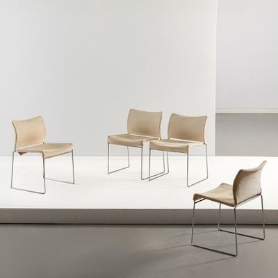 three chairs in a room with a white floor and a white wall