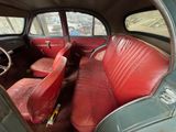 a red leather seat in the back of a car