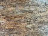 a close up of a piece of wood with writing on it