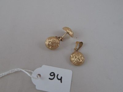 two pairs of gold plated earrings and a tag on a white surface