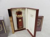 an image of a bottle of perfume in a box next to a box of perfume
