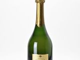 a close up of a bottle of champagne on a white surface