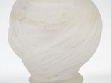 a white vase that is sitting on a table