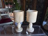 two lamps that are sitting on top of a glass table
