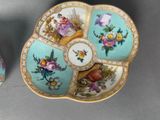 two plates with flowers on them on a table