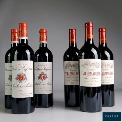 four bottles of red wine are lined up on a table