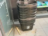 a trash can in the middle of the floor in the kitchen