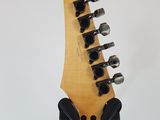 a close up of the headstock of an electric guitar