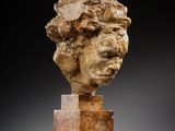 a marble head of a woman on a pedestal
