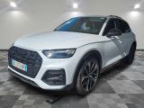 a white audi suv parked on a checkered floor in a showroom