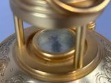 a gold lamp that is on a blue surface