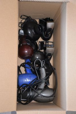 a cardboard box with a bunch of hair dryers in it