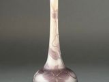 purple and white vase sitting on top of a gray surface