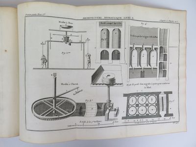 an old book with a drawing of a machine on it