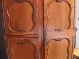 a wooden cabinet with a mirror on top of it