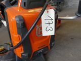 a chainsaw that is sitting on the ground in a garage