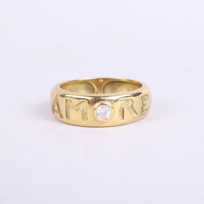 a close up of a gold ring with a diamond in the center