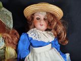 two dolls that are sitting next to each other on a table