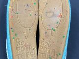a close up of a pair of children ' s shoes with sprinkles on them