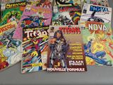 a lot of comic books sitting on a table