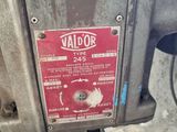 a close up of a machine with a red label on it
