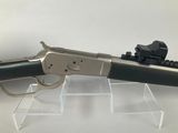 a close up of a gun on display on a clear surface