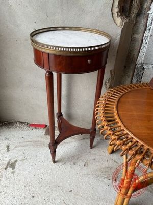 une petite table sur laquelle est posé un plateau, à côté d'un fauteuil en osier