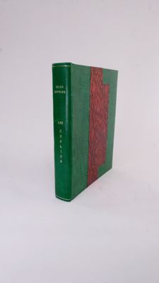 a green and red book sitting on a white surface