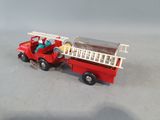 a toy fire truck with a ladder on the back of it