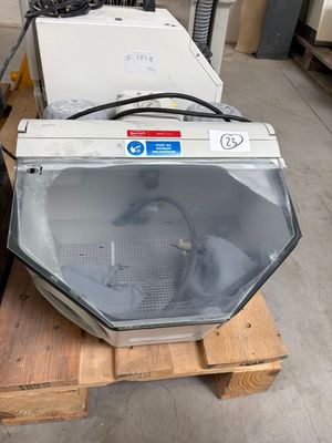 two microwaves sitting on a pallet in a warehouse