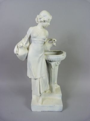 a white statue of a woman with a bird in her hand