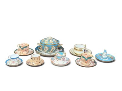 a lot of tea cups and saucers sitting on a table