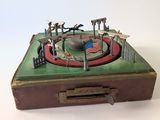 an old suitcase with a toy carousel in it