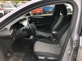 the interior of a car with the door open and the driver ' s seat up