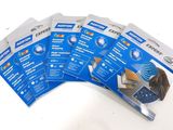 four packs of blue and white adhesives on a white surface