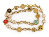 a close up of a bracelet with pearls and charms