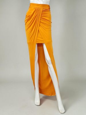 a mannequin wearing an orange skirt and white shirt