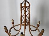 an image of a chandelier made out of bamboo sticks and brass fittings