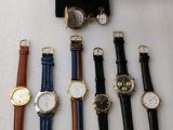 a lot of watches that are on display on a table