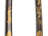 two swords with gold and black designs on them on a white background