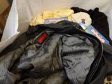 a pile of clothes and a jacket in a box