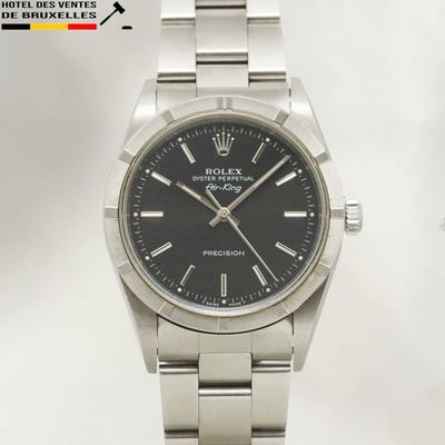 an image of a rolex watch with a black dial on a bracelet
