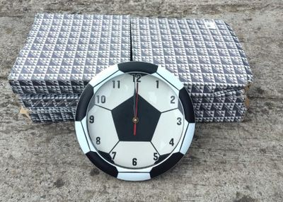 a clock that is sitting on the ground next to a box