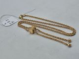 a pair of gold chain bracelets with a lock on a white background