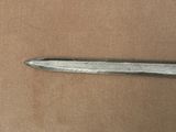 a small knife that is laying on a brown surface