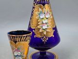 purple and gold glass vase with matching cups and spoons