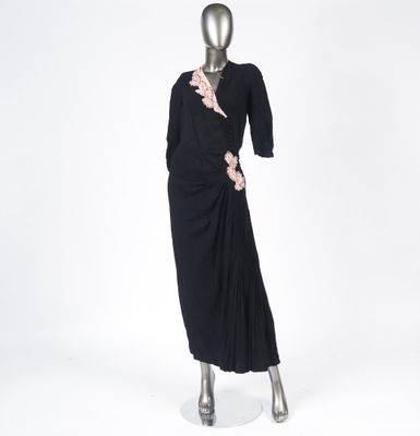 an image of a mannequin wearing a black dress with ruffles on it