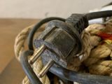 a pile of rope and a power cord on a table