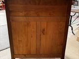 a wooden cabinet that is sitting in the middle of a room
